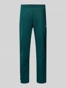 adidas Originals Sweatpants mit elastischem Bund in Dunkelgruen, Größe...