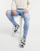 ASOS DESIGN – Spray-on-Jeans aus Powerstretch-Denim mit Abnutzungseffe...